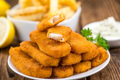 Fried Fish Fingers (selective focus) on wooden background (selective focus)