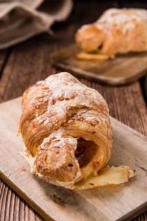 Homemade Ham and Cheese Croissant (selective focus) on wooden background