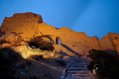 Night shot, Old castle ruins with illuminated stone steps and an archway at night, Kritinia Castle,