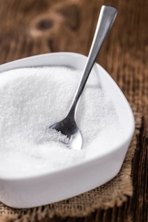 Old wooden table with white Sugar (selective focus, close-up shot)