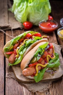 Homemade Hot Dog with fresh vegetables on rustic wooden background