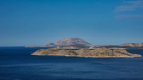 View of an island in the blue sea, surrounded by clear skies and wide expanses of water, Makri