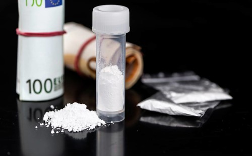 Portion of Cocaine on a dark plate as detailed close-up shot