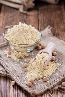 Heap of Chick Pea flour on an old wooden table