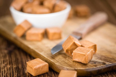 Caramel on a vintage background as detailed close-up shot (selective focus)