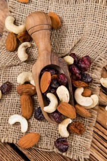 Wooden table with Trail Mix (selective focus, close-up shot)
