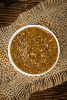 Fresh made German Cuisine (sweet Mustard) on a vintage background (close-up shot)