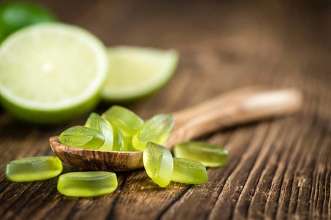 Gummy Candy with lime taste (selective focus) on wooden background