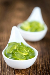Portion of gummy candy (with lime taste) as close-up shot (selective focus)