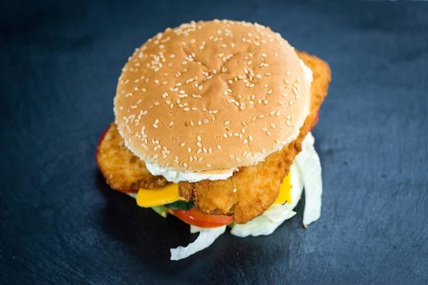 Fish Burger on a slate slab (close-up shot, selective focus)