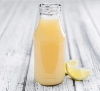 Fresh made Juice (lemon) on a vintage background (close-up shot)