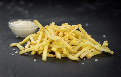 Portion of fresh made crispy French Fries (selective focus, close-up shot)
