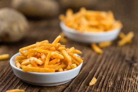 Portion of fried potato sticks (close-up shot, selective focus)