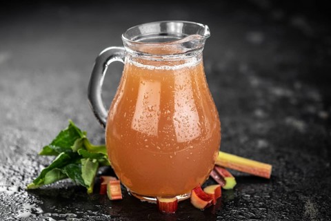 Rhubarb Juice on a rustic background (close up shot, selective focus)