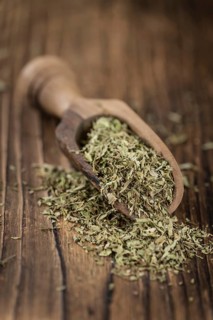 Portion of Stevia Leaves (dried, close-up shot) on wooden background