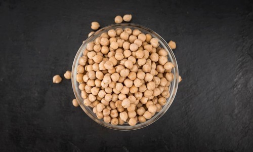 Portion of dried Chickpeas on a rustic slate slab, selective focus, close-up shot