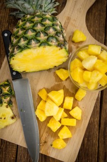 Fresh made Pineapple (sliced) on a vintage background as detailed close-up shot