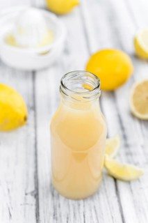 Fresh made Juice (lemon) on a vintage background (close-up shot)