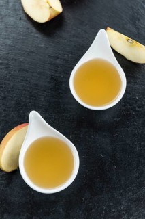 Portion of fresh made Applesauce (close-up shot) on vintage background