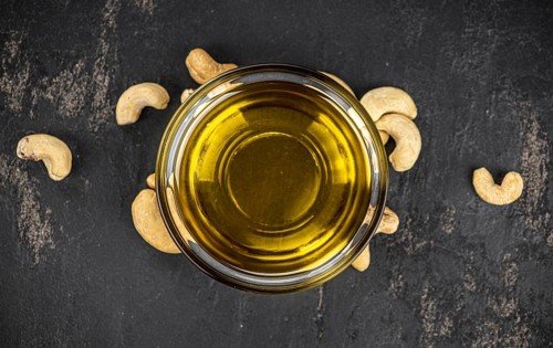Fresh made Cashew Oil (detailed close up shot, selective focus)
