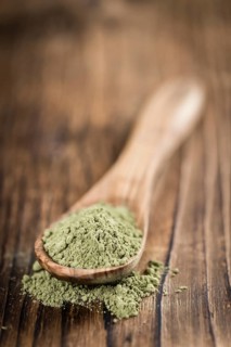 Stevia leaf powder (detailed close-up shot) on rustic wooden background