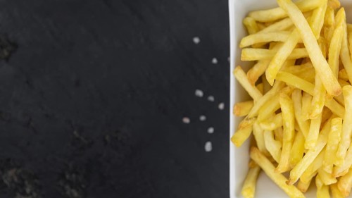 Portion of fresh made French Fries (close-up shot, selective focus)