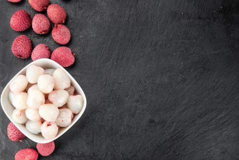 Portion of Litchis as detailed close up shot on a slate slab (selective focus)