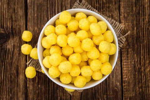 Cheese Balls on rustic wooden background (close-up shot)