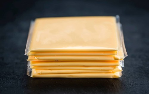 Portion of sliced Cheese (close-up shot, selective focus)