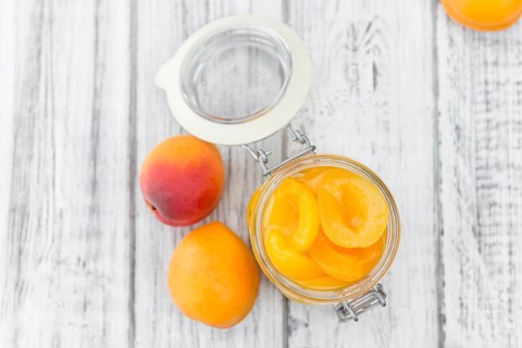 Pickled Apricots on a vintage background as detailed close-up shot (selective focus)