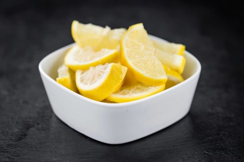 Fresh made Lemon (sliced) on a vintage background (close-up shot)