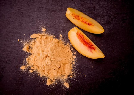 Peach powder on a vintage slate slab as detailed close-up shot, selective focus