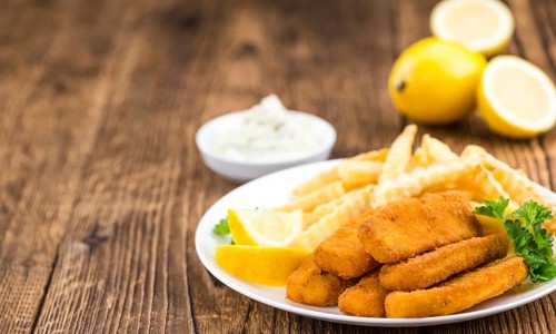 Fried Fish Fingers (selective focus) on wooden background (selective focus)