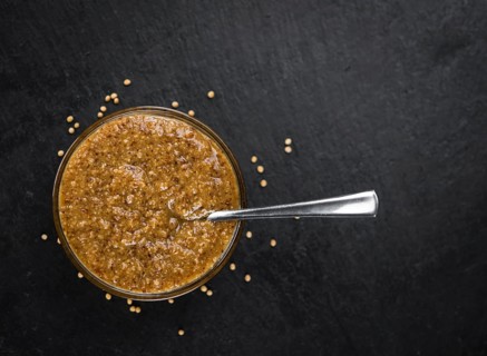 Fresh made German Cuisine (sweet Mustard) on a vintage background (close-up shot)