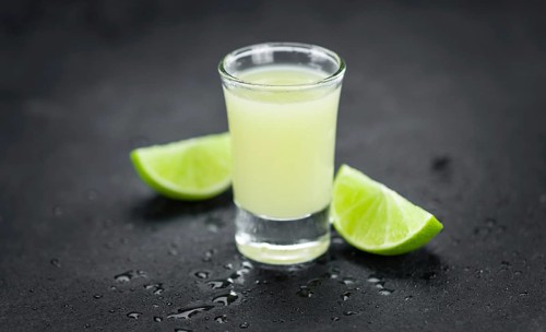Portion of Fresh Lime Juice on a rustic slate slab (selective focus, close-up shot)