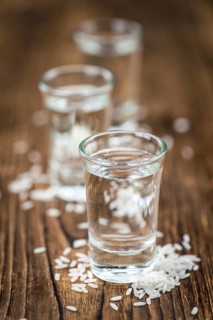 Japanese Sake drink on an old wooden table (close-up shot)