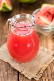 Watermelon Smoothie on rustic wooden background (close-up shot)