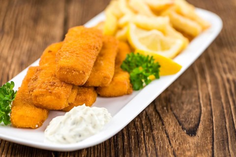 Fried Fish Fingers (selective focus) on wooden background (selective focus)