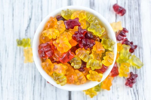 Wooden table with Gummy Bears (close-up shot, selective focus)