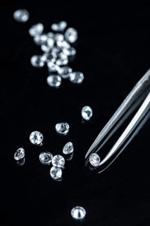 Small Diamonds on dark background as close up shot (selective focus)