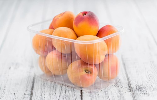 Apricots on an old wooden table as detailed close-up shot (selective focus)