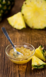 Fresh made Pineapple Jam on an old and rustic wooden table, selective focus, close-up shot