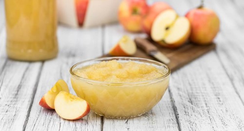 Portion of homemade Applesauce (selective focus, close-up shot) on vintage background