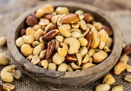 Roasted and salted nuts as detailed close up shot (selective focus)