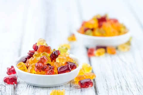 Fruity Gummy Bears (close-up shot) on an old wooden table
