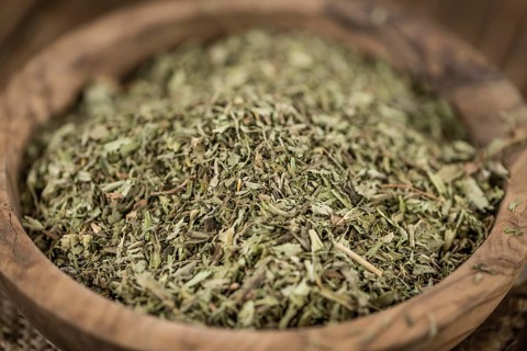 Heap of dried Stevia leaves (sweetener) on vintage background (close-up shot)