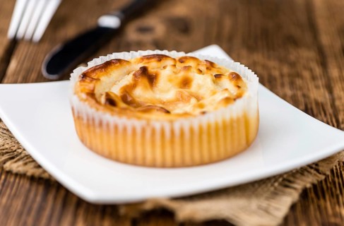 Fresh made Mini Cheesecake on an old and rustic wooden table (selective focus, close-up shot)