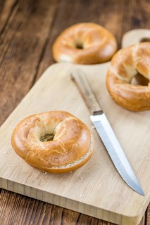 Fresh baked Bagels on a wooden table (selective focus, close-up shot)