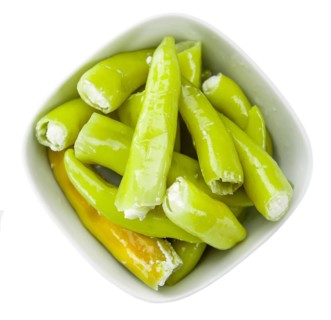 Pimientos (filled with cream cheese) isolated on white background (selective focus, close-up shot)