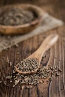 Dried Valerian roots (detailed close-up shot) on wooden background